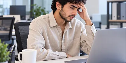 Woman at a laptop reviewing her physician-signed doctor's note
